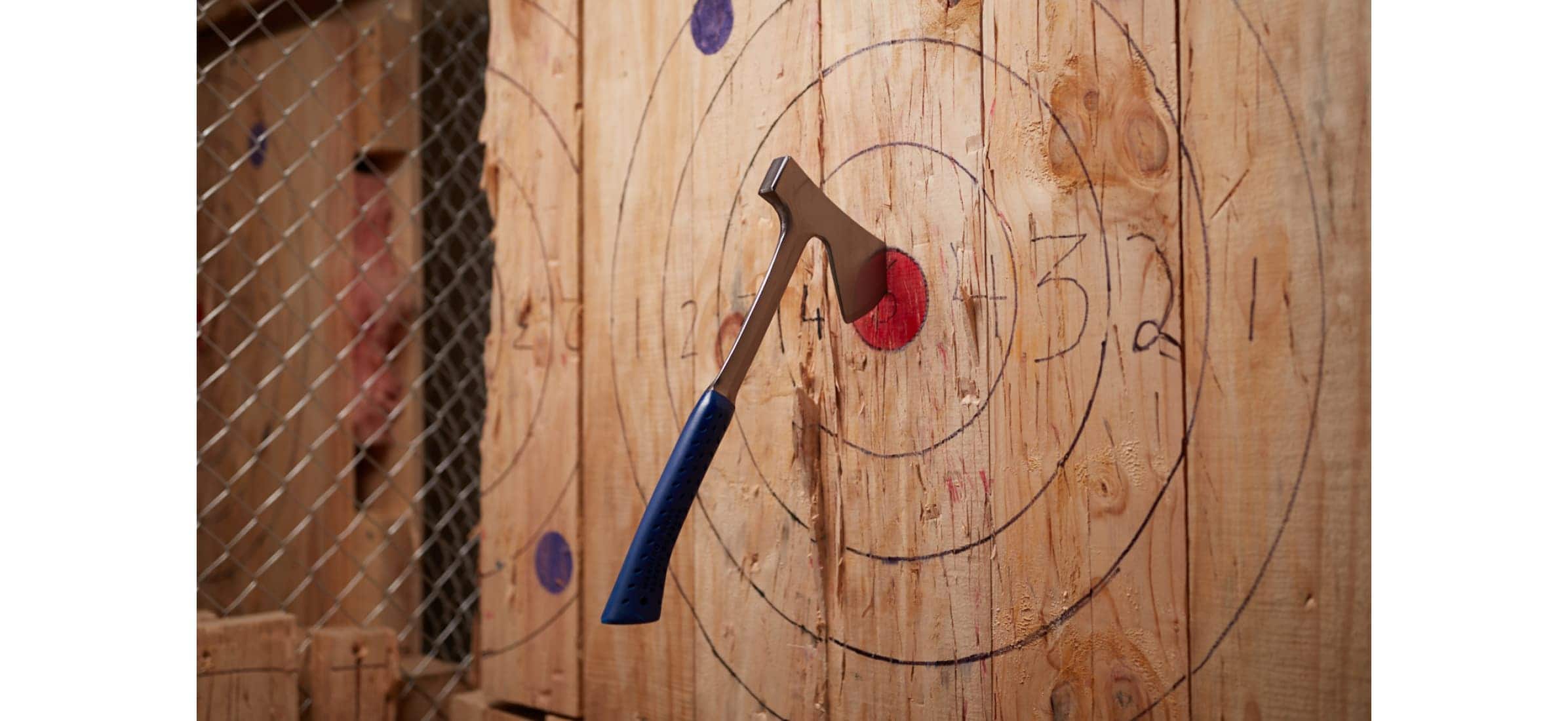 An axe embedded in the bullseye of a target.